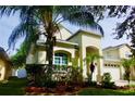 Stunning two-story home featuring lush landscaping, beautiful plantings and a welcoming front entrance at 18439 Red Willow Way, Land O Lakes, FL 34638