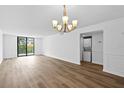 Bright living room with laminate flooring and sliding glass doors to the balcony and laundry closet at 201 W Laurel St # 308, Tampa, FL 33602