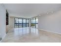 Bright living room with tiled floors and large windows offering scenic water views and balcony access at 2413 Bayshore Blvd # 1903, Tampa, FL 33629