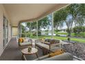 Inviting screened-in patio with comfortable seating and a serene lake view at 25737 Frith St, Land O Lakes, FL 34639
