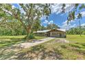 Charming single-story home with mature tree coverage and a long driveway at 2610 Crestview Rd, Wimauma, FL 33598