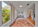 Bright sunroom leading into living area, featuring beautiful tile and arched doorway at 301 Kingston S St, St Petersburg, FL 33711