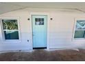 Up close front porch showcasing light blue door and white siding framed by symmetrical windows at 368 6Th Nw St, Largo, FL 33770