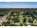 Expansive aerial view showcasing a neighborhood with mature trees, highlighting the location of the house at 3700 56Th N St, St Petersburg, FL 33710