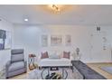 Cozy living room with a white sofa, modern art, and ample natural light, creating a welcoming atmosphere at 3836 N Lake Dr # 121, Tampa, FL 33614