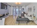 Inviting living room with neutral tones, a sliding glass door to the balcony, and comfortable seating arrangements at 3836 N Lake Dr # 121, Tampa, FL 33614