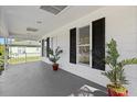 Cozy front porch with black shutters, offering a relaxing spot for outdoor enjoyment at 4112 E Ellicott St, Tampa, FL 33610