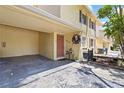 Exterior view of a townhouse with covered parking, a decorative wreath, and charming curb appeal at 7608 Pasa Dobles Ct, Tampa, FL 33615