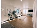 Bright living room with wood-look floors, recessed lights, and large windows that provide ample natural light at 811 40Th S Ave, St Petersburg, FL 33705