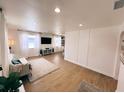 Spacious living room with wood-look floors, recessed lights, and large windows that provide ample natural light at 811 40Th S Ave, St Petersburg, FL 33705