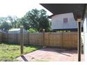 Fenced backyard with brick patio and wood fence at 8524 Fish Lake Rd, Tampa, FL 33619