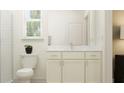 Bathroom featuring white cabinets, marble countertop, modern fixtures, and natural light at 9360 Gladsome Dr, Land O Lakes, FL 34637