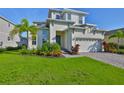 Charming two-story home with manicured lawn, beautiful landscaping, and a paver driveway at 955 Signet Dr, Apollo Beach, FL 33572