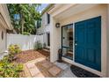 Inviting front entrance with a stylish blue door and charming garden area at 103 E Davis Blvd # B, Tampa, FL 33606
