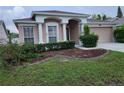 Charming single-story home featuring a well-manicured lawn and a two-car garage at 10539 Egret Haven Ln, Riverview, FL 33578