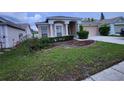 Charming single-story home featuring a well-manicured lawn and a two-car garage at 10539 Egret Haven Ln, Riverview, FL 33578