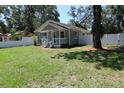 Charming single-story home featuring a well-maintained lawn and inviting front porch at 1103 E Lambright St, Tampa, FL 33604