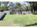 Charming single-story home featuring a well-maintained lawn and inviting front porch at 1103 E Lambright St, Tampa, FL 33604