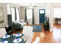 Bright living room with hardwood floors, stylish furniture, and a modern ceiling fan at 1103 E Lambright St, Tampa, FL 33604