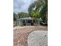 Charming single-story home with brick driveway and tropical landscaping at 111 12Th Ave, Indian Rocks Beach, FL 33785