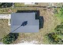 A bird's-eye view of the home showing the dark roof, yard, and surrounding greenery at 111 W Keyes Ave, Tampa, FL 33602