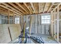 Interior of a room showing the exposed framework and concrete block walls ready for finishing at 111 W Keyes Ave, Tampa, FL 33602
