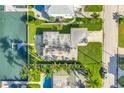 Overhead view of home showing roof, lawn, dock, seawall, and canal at 11240 6Th E St, Treasure Island, FL 33706