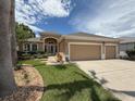 Charming single-story home with a well-manicured lawn, mature trees and a three car garage at 11610 Grove Arcade Dr, Riverview, FL 33569