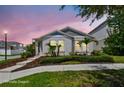 Charming single-story home with well-manicured landscaping, stone walkway, and inviting curb appeal at 13027 Pennybrook Dr, Riverview, FL 33579