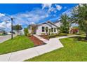 Well-maintained home with manicured lawn, tidy mulch beds, and a welcoming walkway to the front door at 13027 Pennybrook Dr, Riverview, FL 33579