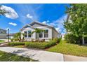 Well-maintained home with manicured lawn, tidy mulch beds, and a welcoming walkway to the front door at 13027 Pennybrook Dr, Riverview, FL 33579
