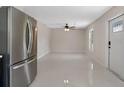 Open concept living room featuring modern stainless steel refrigerator and plenty of space at 163 Swift St, Port Charlotte, FL 33954