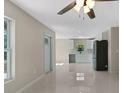 Open concept living room with plenty of natural light and a modern ceiling fan at 163 Swift St, Port Charlotte, FL 33954