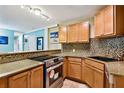 Well-equipped kitchen featuring modern appliances, stylish backsplash, and ample counter space at 3315 58Th S Ave # 115, St Petersburg, FL 33712