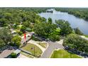 Aerial view of home near a lake featuring a large lot and mature trees at 4018 E Bluff Ave, Tampa, FL 33617
