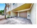 Townhouse front entrance features a garage and entrance steps with brick pavers and coastal design at 459 Haven Point Dr, Treasure Island, FL 33706