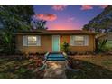 Cozy home featuring a colorful sunset, neat landscaping, and a welcoming walkway leading to the front entrance at 4616 5Th N Ave, St Petersburg, FL 33713