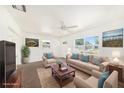 Bright living room featuring neutral furnishings, ceiling fan, and natural light from the windows at 4816 N Fremont Ave, Tampa, FL 33603