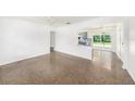 Bright living space featuring a terrazzo floor and open access to the kitchen at 4816 N Fremont Ave, Tampa, FL 33603
