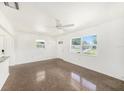 Inviting living room featuring terrazzo flooring and large windows for ample natural light at 4816 N Fremont Ave, Tampa, FL 33603