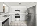 Bright kitchen features updated appliances, tile floors and white subway tile backsplash at 551 Bay St, Dunedin, FL 34698