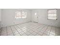 Bright living area with tiled floors, white walls, and natural light from large windows at 551 Bay St, Dunedin, FL 34698