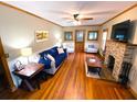 Cozy living room with hardwood floors, stone fireplace, and comfortable seating at 5812 Montana Ave, New Port Richey, FL 34652