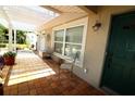 Welcoming front porch with tiled flooring, seating, and a view of the landscaped yard at 6045 2Nd N Ave, St Petersburg, FL 33710