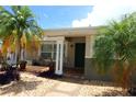 Inviting covered front porch with tiled flooring, seating, and mature palm trees at 6045 2Nd N Ave, St Petersburg, FL 33710