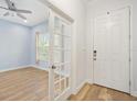 Bright entryway featuring wood floors and a view into the adjacent living space at 6519 Watson Rd, Riverview, FL 33578