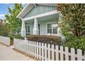 Inviting home exterior with a white picket fence and lush landscaping at 6519 Watson Rd, Riverview, FL 33578