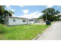 Charming house exterior with well-maintained lawn and street view at 708 E Annie St, Tampa, FL 33612