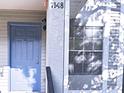 A front exterior view showcases the door and window under natural shadow at 7148 E Bank Dr # 7148, Tampa, FL 33617