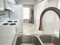 An updated kitchen with white appliances and a view into the living area at 7148 E Bank Dr # 7148, Tampa, FL 33617
